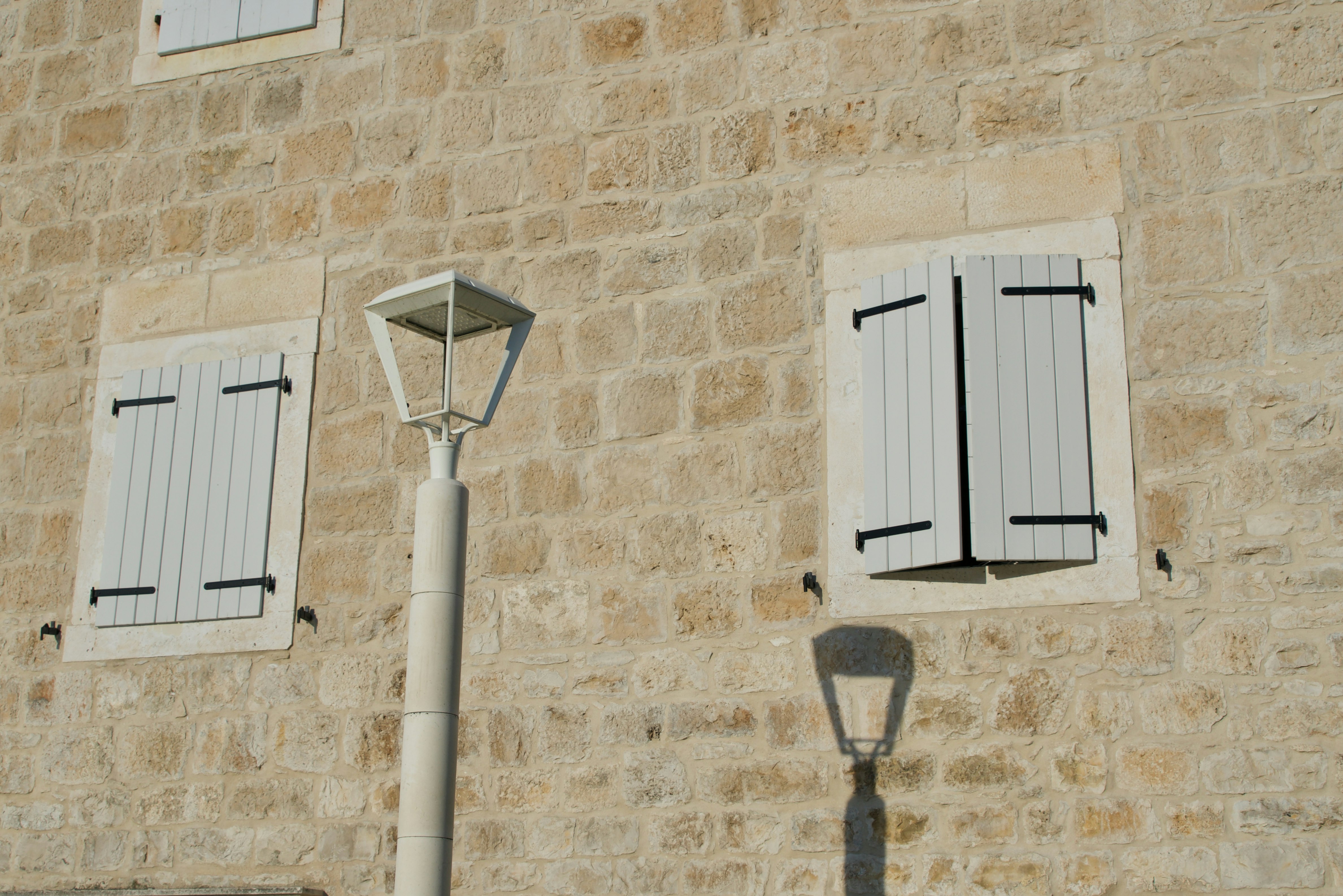 white wooden door on brown brick wall